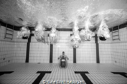 A group of lifesavers playing in the pool on a photo shoot. by Rune Edvin Haldorsen 